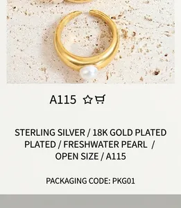 Close-up of a gold-plated open ring with a single white pearl on a textured stone surface