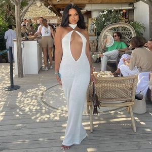 Detail of white halter neck maxi dress featuring sexy cutout and metal link decor