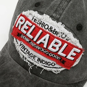 Vintage washed grey baseball cap featuring embroidered Reliable patch and distressed edges