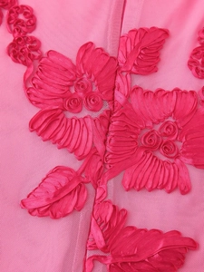 Detail of 3D rose embroidery and floral textures on pink mesh bodycon dress fabric