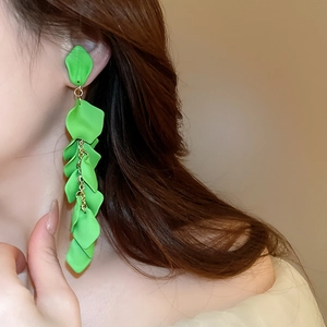 Detail showing long green layered rose petal tassel earrings on a fashion model