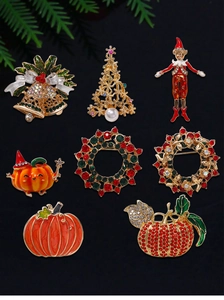 Flat lay detail of Christmas and Halloween brooches with colorful rhinestones on black background