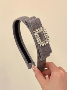 Détail du serre-tête floqué gris avec boucle carrée en strass scintillants