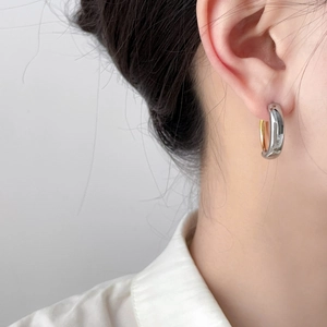 Polished dual-tone silver and gold C-shaped chunky hoop earrings for minimalist style