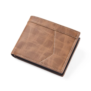 Detail shot of men's brown bifold wallet showing cross-pattern texture and white stitching