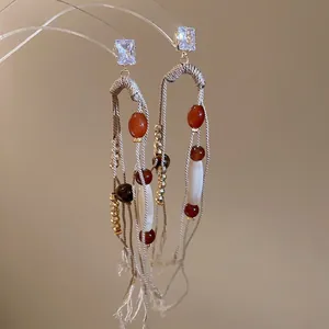 Ethnic tassel earrings with cubic zirconia and woven beads on acrylic stand display