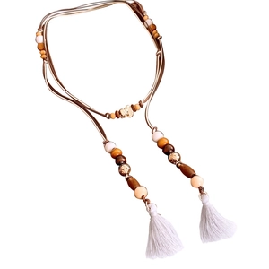 Ethnic bohemian waist chain with brown wood beads and white tassels on white background