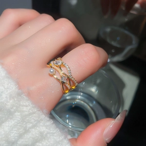 Detail of 18k gold plated multi-layer wave ring with pearls and cubic zirconia