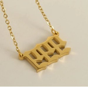 Macro shot of 2022 hollowed number pendant necklace in 18k gold plated stainless steel