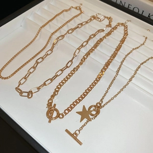 5-piece gold-tone metal star and chain necklace set with OT buckles in Y2K style