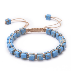 Detailed macro of a Bohemian square blue imperial stone woven bracelet with adjustable cord