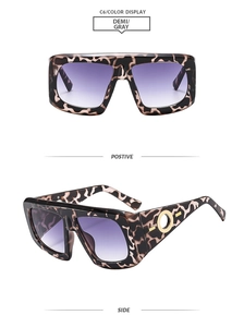 Detail of tortoiseshell square sunglasses with purple gradient lenses and gold side buckle