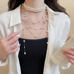 Elegant multi-layer pearl fringe necklace with silver chains and layered pearl strands