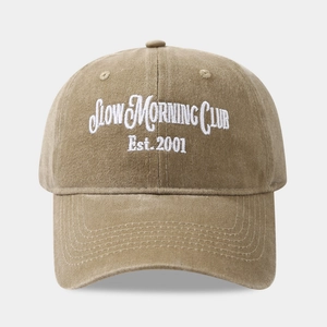 Detail of Slow Morning Club white embroidery on a khaki washed cotton baseball cap