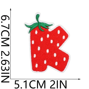 Detail of strawberry-themed letter K patch with size markers 6.7cm by 5.1cm