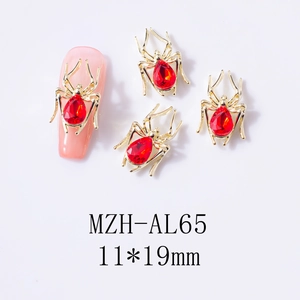 Macro view of gold spider nail art charm with red crystal and 11x19mm size detail