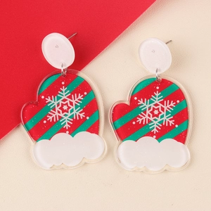 Close-up of festive Christmas glove earrings with red and green stripes and snowflake motif