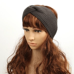 Detail view of dark grey cable knit headband featuring a stylish twisted knot design