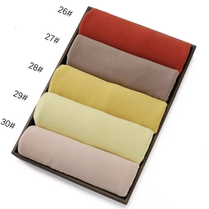 Detailed view of jersey cotton hijabs in five warm colors with soft knit texture