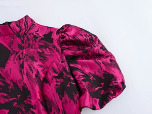 Detail of rose red jacquard mini dress featuring puffy sleeves and elegant stand collar
