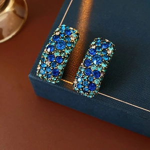 Gros plan de boucles d'oreilles bohèmes rectangulaires serties de strass turquoise