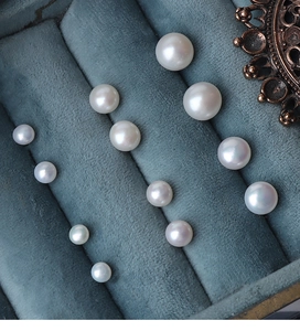 Macro shot of loose natural freshwater pearls in various sizes on a velvet jewelry tray