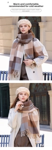Close-up of brown and beige checkered cashmere scarf with long tassels and winter hat