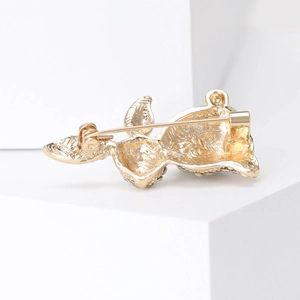 Elegant gold metal rabbit brooch back view with detailed pin structure on white background