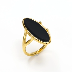 Macro detail of 18K gold titanium steel ring featuring an oval black shell inlay