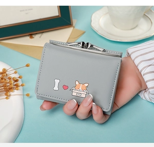 Short tri-fold wallet for women featuring cute corgi and heart prints held by hand