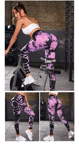 Dettagli dei leggings yoga tie-dye rosa e neri a vita alta in un ambiente da palestra