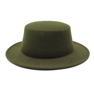 Macro shot of dark green wool felt flat top boater hat showing fine texture and brim