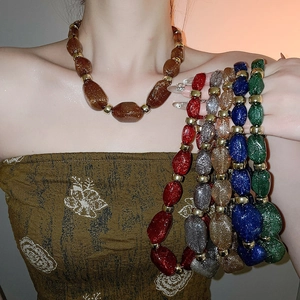 Close-up of colorful irregular acrylic beaded necklaces with glitter finish for women