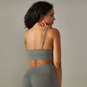 Detail of grey seamless knit sports bra showing the back strap design and fabric texture