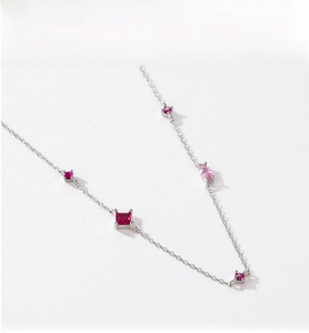 Close-up of S925 silver necklace featuring vibrant red and pink geometric zircon stones