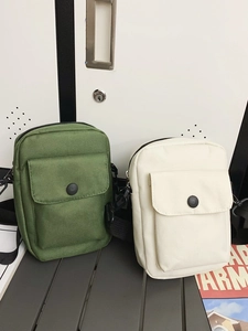 Minimalist canvas messenger bags in army green and beige with adjustable shoulder straps