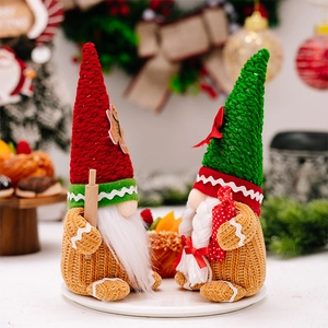 Close-up of plush Christmas gnomes with gingerbread patterns and knitted hats