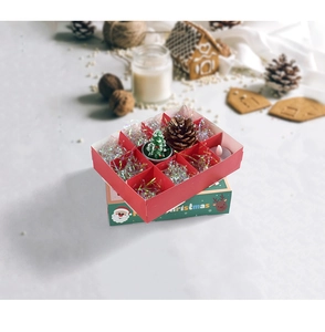 Detail of Christmas surprise box with 12 grids, festive miniature trees and pine cones