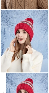 Detail of red pom-pom and winter snowflake pattern on thick knitted wool beanie