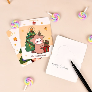 Detailed view of Merry Christmas greeting cards with reindeer patterns and matching pens