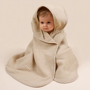 Close-up of beige hooded baby bath towel in soft breathable four-layer cotton gauze