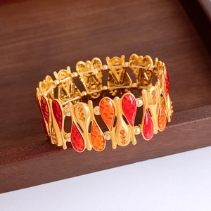Macro shot of vintage teardrop enamel bracelet with golden metal and amber crystals