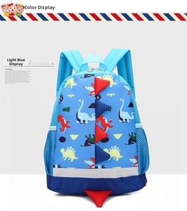 Detailed side view of light blue dinosaur kids backpack with 3D fins and mesh pocket