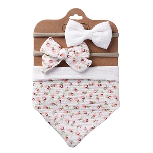Floral cotton baby bib and bow headband set on display card for infants