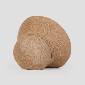 Detailed close-up of breathable camel knit sun hat showing fine crochet texture and logo tag