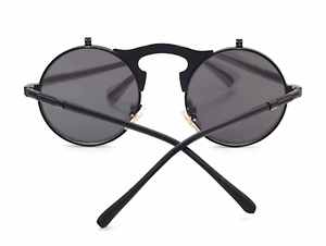 Front view of black steampunk flip-up sunglasses with round metal frames on white background