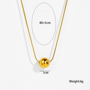 Macro view of gold minimalist beaded necklace showing snake chain and 1cm polished round pendant