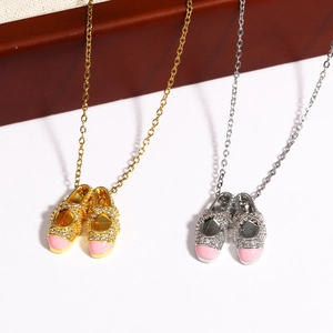Close-up of pink ballet slipper necklaces in gold and silver finish with sparkling crystals