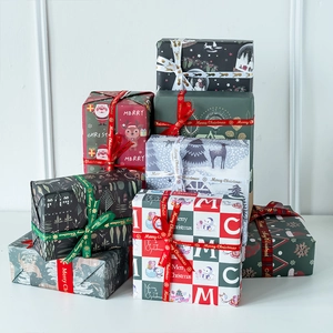 Christmas white kraft wrapping paper set with reindeer patterns and Merry Christmas ribbons