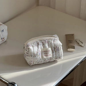 Quilted cotton makeup bag with cute rabbit floral print and zipper closure in cream